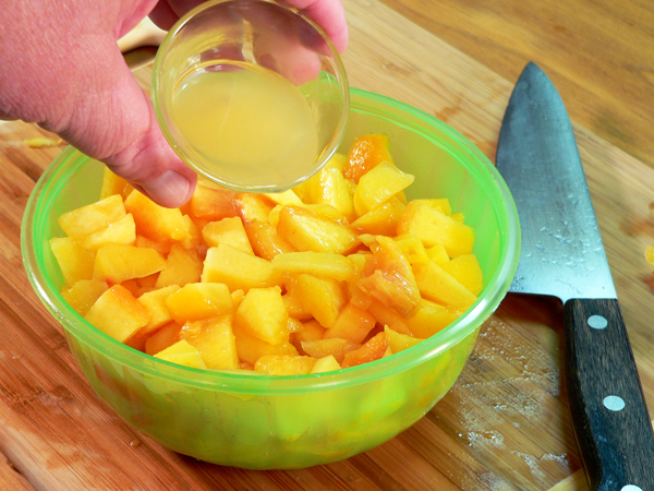 Peach-Preserve-Ice-Cream_09_add-lemon-juice Peach Preserve Ice Cream, add the lemon juice to the cut peaches.