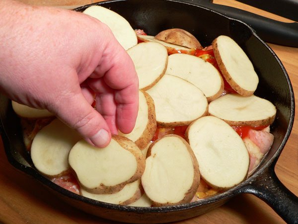 Skillet BBQ Chicken, layer potatoes in skillet.